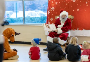 Santa reading a story to kids