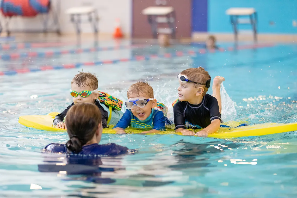 three boys in swim lessons