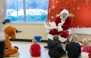 Santa reading a story to kids